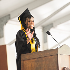 A student speaking at graduation. Links to Gifts of Life Insurance